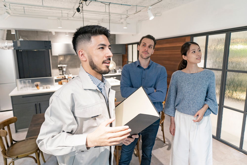 Young,Man,And,Woman,Listening,To,The,Interior,Designer's,Explanation