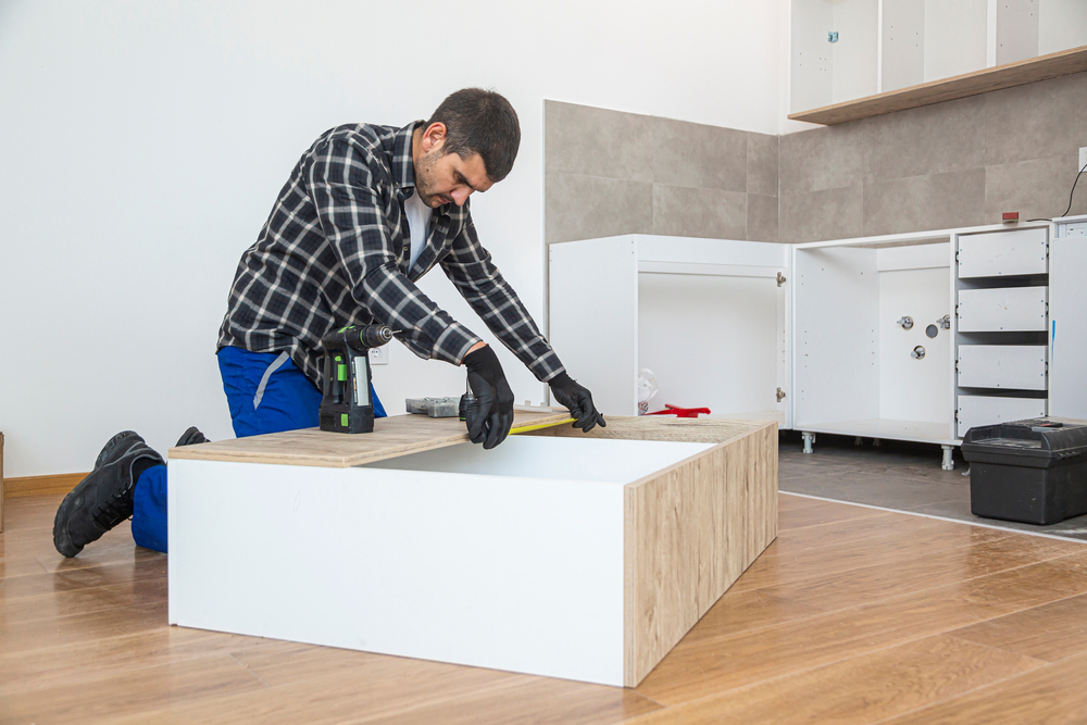 Carpenter,Measuring,Shelves,In,An,Empty,Apartment,,Where,He,Started